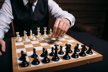 Serious male chess player makes victory moveの写真素材