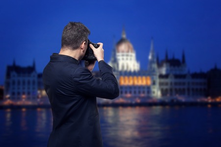 Photographer takes pictures of palace on the riverの写真素材