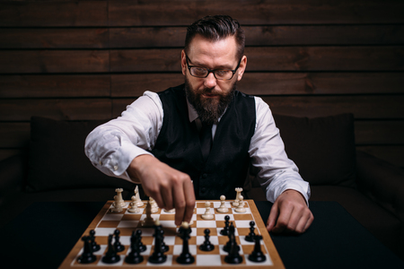 Serious male chess player makes victory moveの写真素材