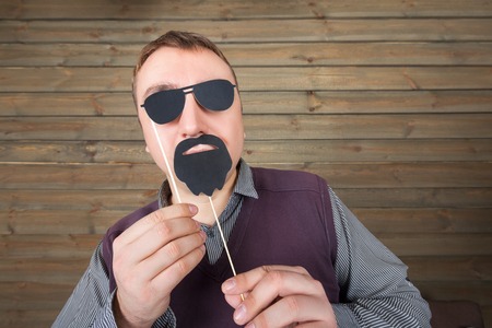 Male with funny sunglasses and beard on a stickの写真素材