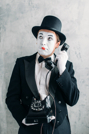 Pantomime actor performing with retro telephoneの写真素材