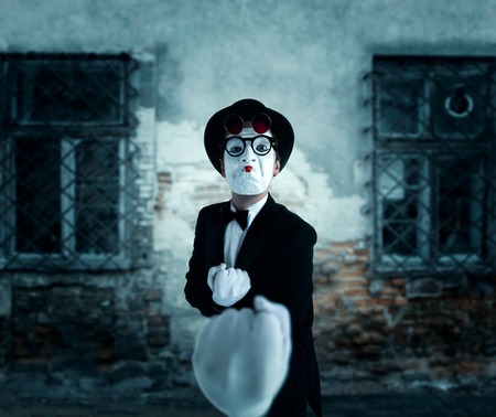 Pantomime actor in glasses shows boxerの写真素材