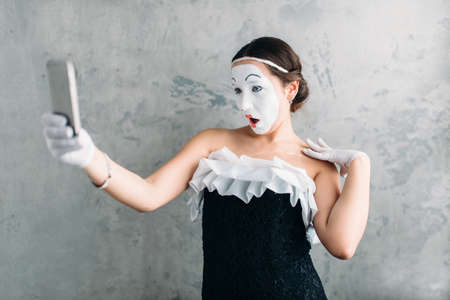 Pantomime theater actress makes selfie on cameraの写真素材