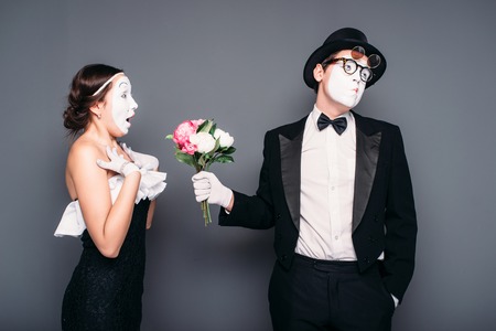 Pantomime actors performing with flower bouquetの写真素材