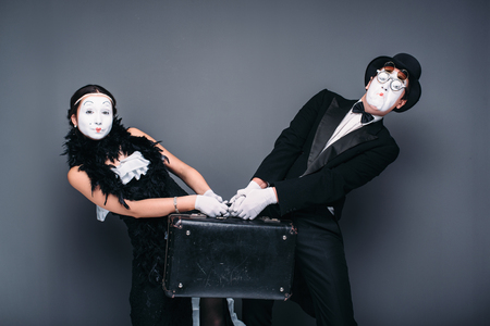Mime actor and actress performing with suitcaseの写真素材
