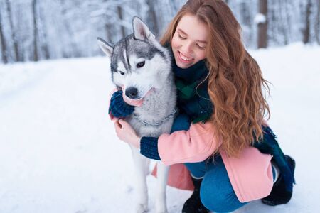 Pretty woman hugs with siberian huskyの写真素材