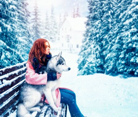 Woman sitting on the bench with siberian huskyの写真素材