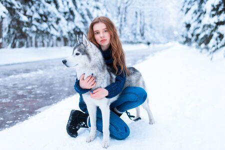 Woman hugs with siberian husky, friendship foreverの写真素材