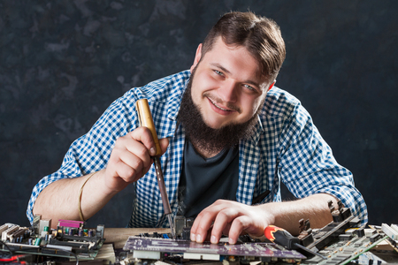 Repairman fixing problem with soldering toolの写真素材