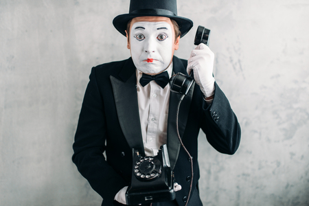 Pantomime actor performing with retro telephoneの写真素材