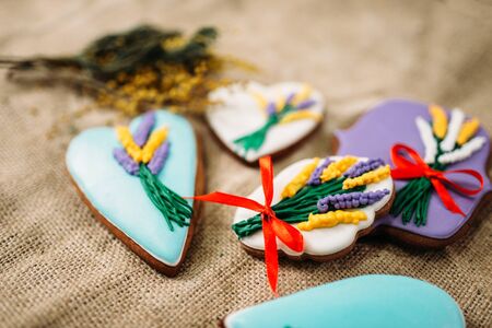 Cookies in glaze with pictures, burlap backgroundの写真素材