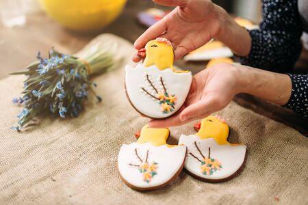 Female hands holds sweet cookies with picturesの写真素材