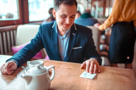 Happy man read love note with a phone numberの写真素材