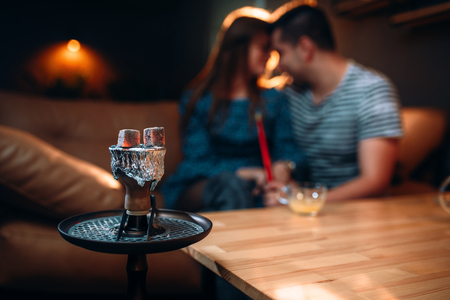Young couple relax and smoking hookahの写真素材