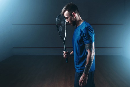 Squash game concept, male player with racketの写真素材