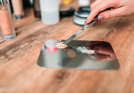 Female make up artist hand prepares cosmeticsの写真素材