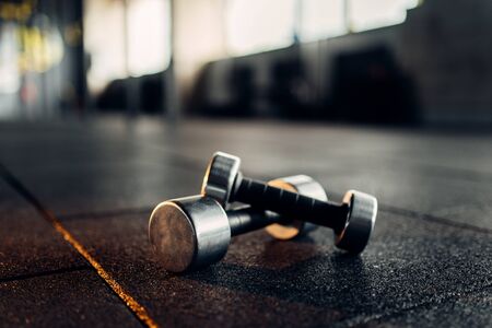 Dumbbells on rubber floor closeup, fitness clubの写真素材