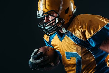 American football offensive player with ballの写真素材