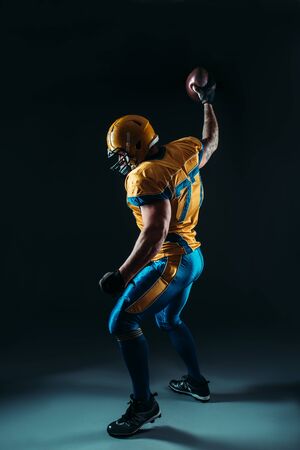 American football player with ball in hand, NFLの写真素材