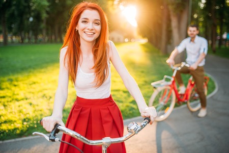 Couple on retro bicycles on sunset, romantic dateの写真素材