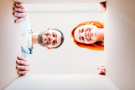 Man and woman, view from inside the cardboard boxの写真素材