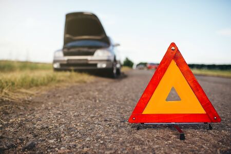 Broken car concept, breakdown triangle on roadの写真素材