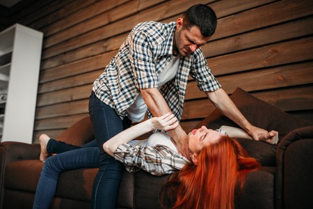 Man strangles woman with a tie, domestic violence