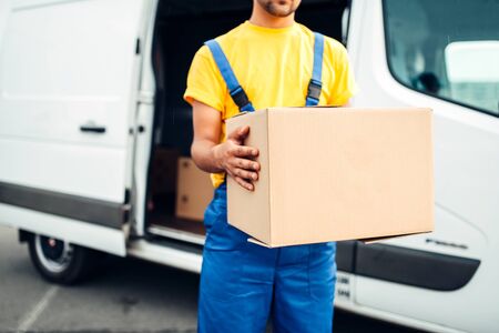 Male person in uniform holds cardboard boxの写真素材