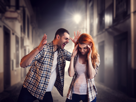 Evil man screams at woman, family quarrelの写真素材