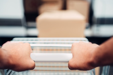 Male hands with cargo trolley, cargo deliveryの写真素材