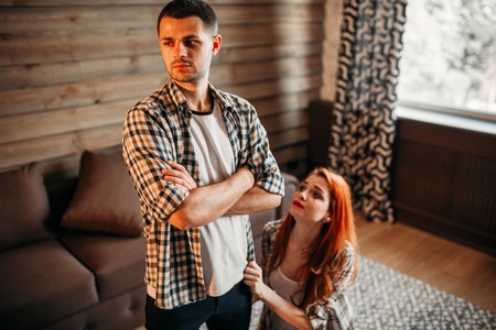 Family quarrel, woman on her knees apologizesの写真素材