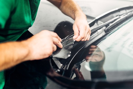 Worker hands installs car paint protection filmの写真素材