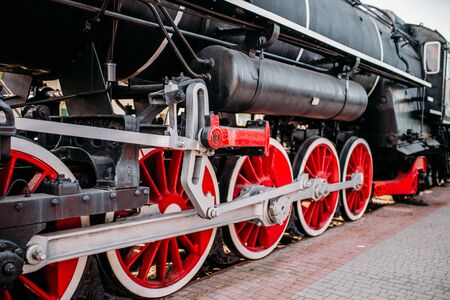 Old steam train, red wheels closeupの写真素材