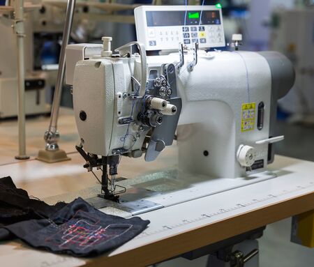 Sewing machine and cloth in cutting shop, nobodyの写真素材