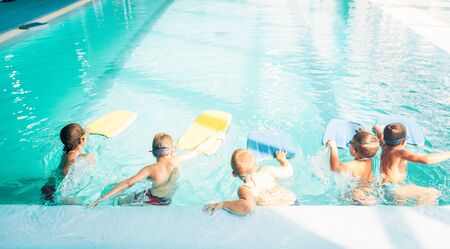 Boys starts simming in pool with plankの写真素材