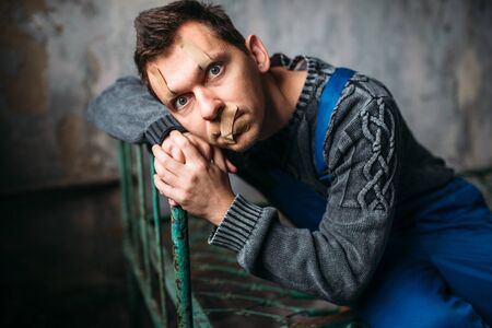 Madman, eyelids and mouth sealed with plasterの写真素材