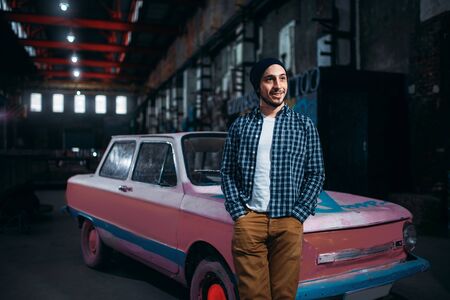Stalker, traveler pose against USSR retro car