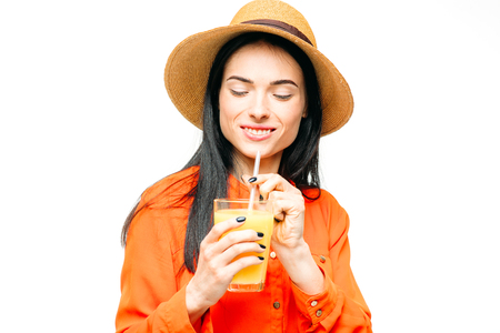 Woman drinks fresh juice fruit, white backgroundの写真素材