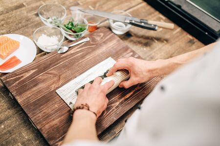 Male cook making seafood, asian kitchenの写真素材