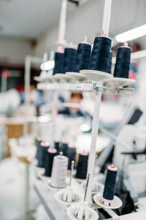 Black threads on spools closeup, overlock machineの写真素材