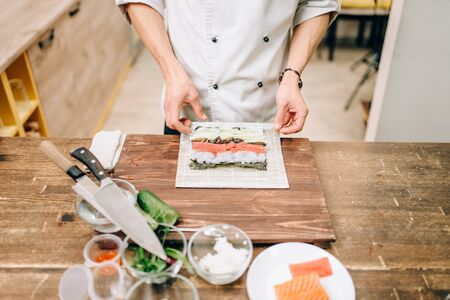 Male cook making sushi, asian kitchenの写真素材