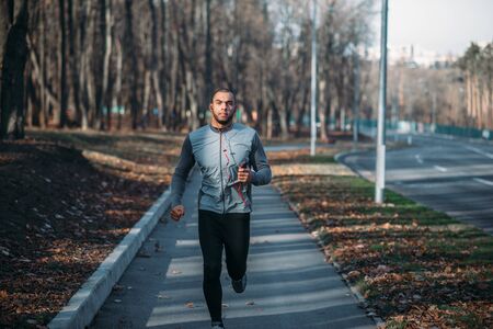 Male runner in sportswear on training outdoorの写真素材