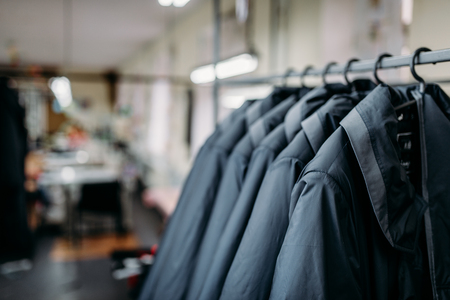 Row of jackets on hangers, clothing store, fabricの写真素材