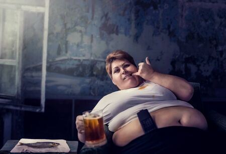 Overweight woman with glass of beer, obesityの写真素材