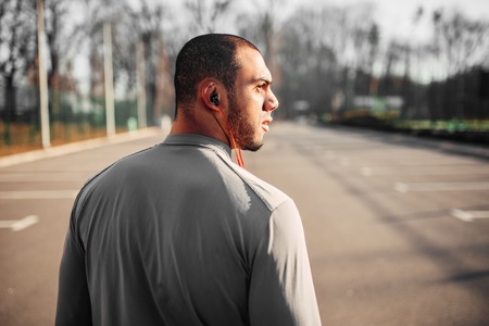 Athlete in headphones before jogging in parkの写真素材