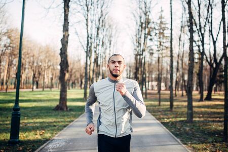 Jogger in motion, running in autumn parkの写真素材
