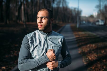 Male jogger in motion on workout outdoors