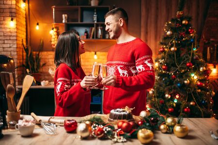Couple holds glasses with champagne, christmasの写真素材