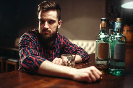 Smiling man sitting at the bar counter,の写真素材