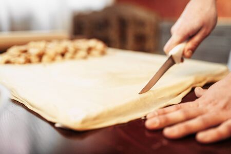 Male chef prepares apple strudelの写真素材
